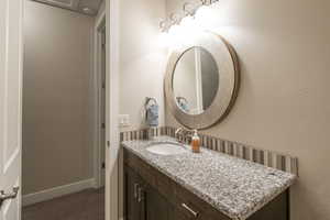 Bathroom featuring vanity and a textured wall