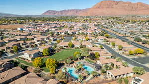 Aerial perspective of suburban area with mountains and a pool area