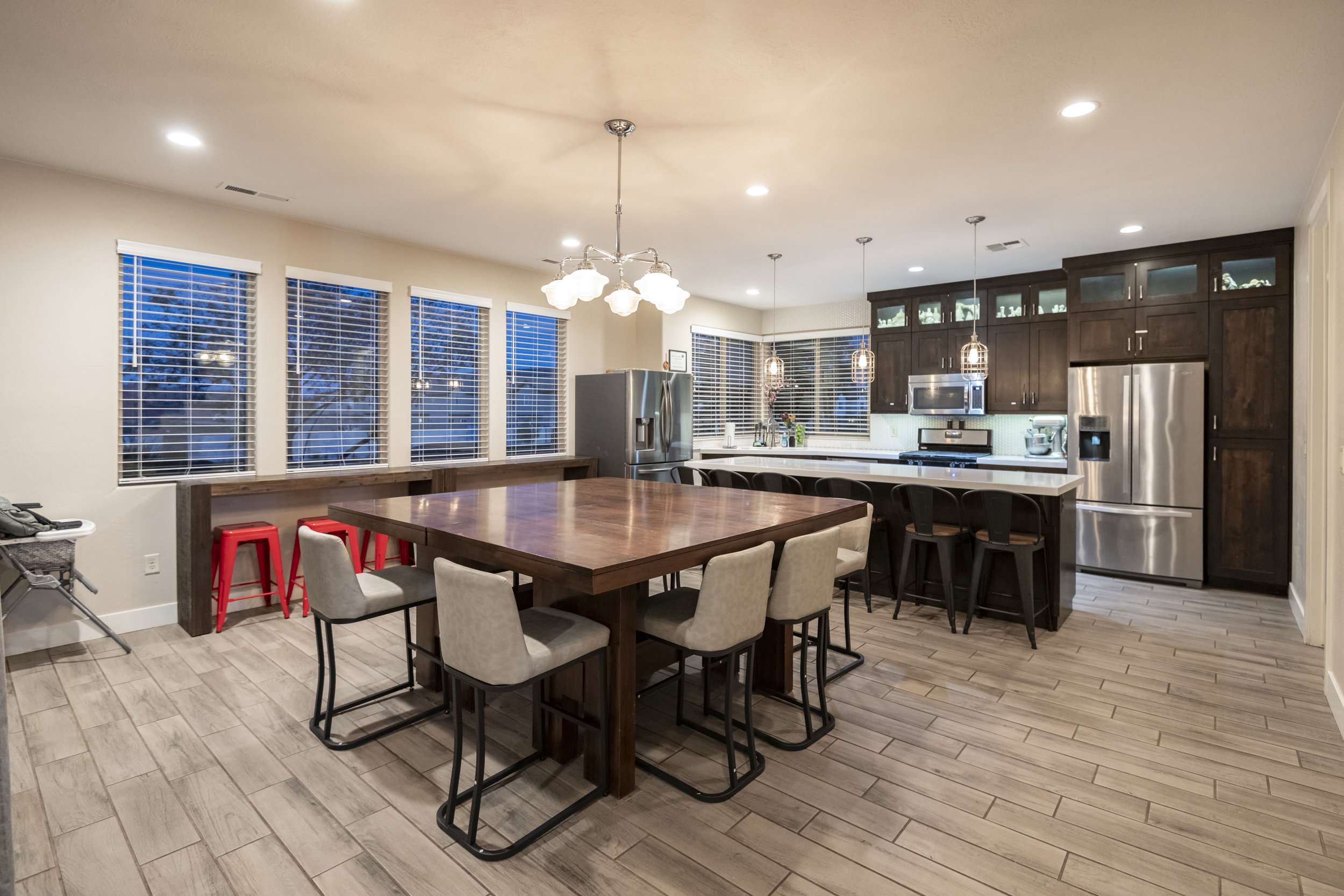 Dining room with wood tiled floors and suspended lighting