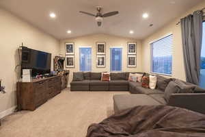 Living area with recessed lighting, a ceiling fan, and light carpet