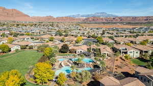 Aerial perspective of suburban area with mountains and a pool area