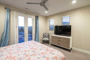 Bedroom featuring french doors, light colored carpet, access to outside, a ceiling fan, and recessed lighting