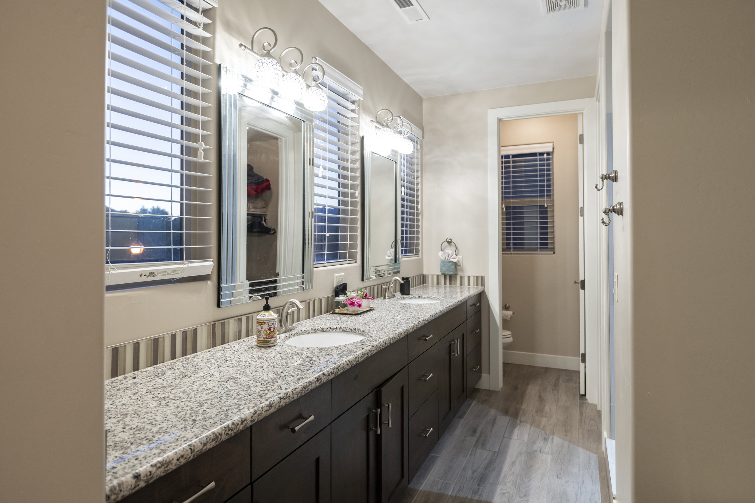 Bathroom with double vanity and light wood-style floors