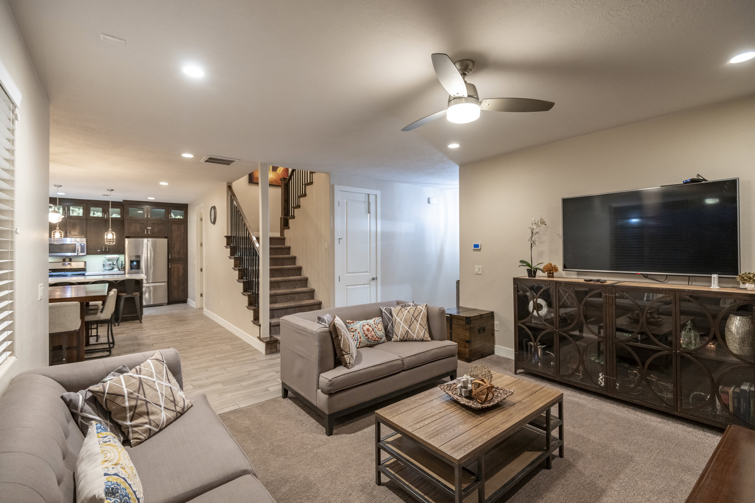 Living area with ceiling fan, recessed lighting, and light wood-style flooring