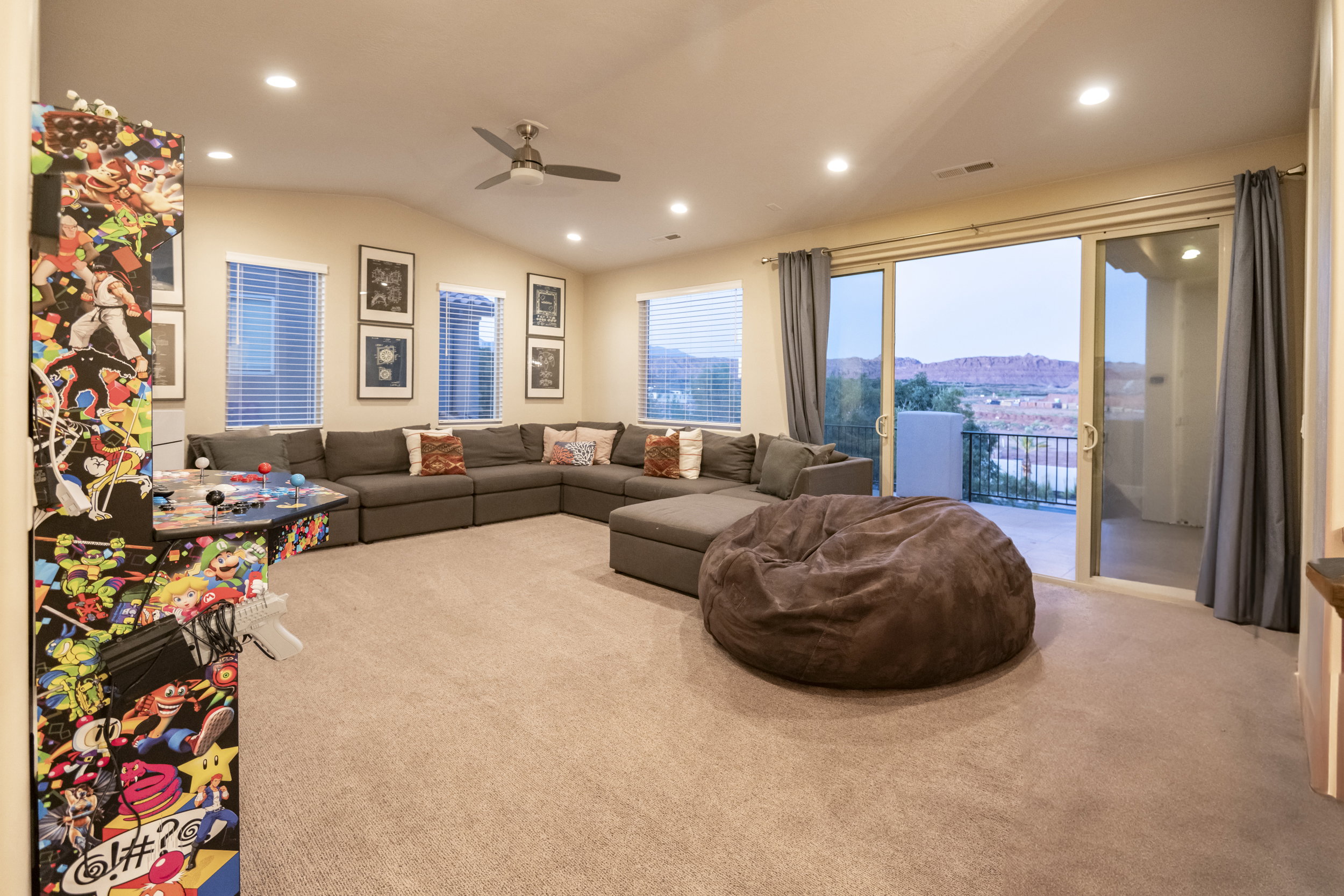 Living room with lofted ceiling, carpet floors, a ceiling fan, recessed lighting, and a mountain view