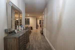 Corridor featuring wood finish floors and recessed lighting