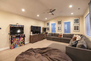 Carpeted living room with ceiling fan and recessed lighting