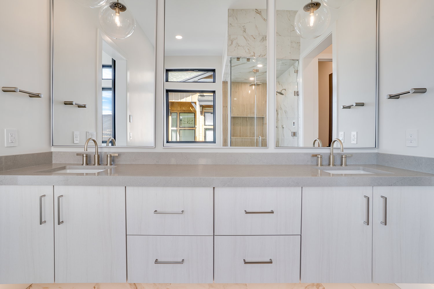 Bathroom with double vanity and a marble finish shower
