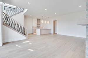 Unfurnished living room featuring recessed lighting and light wood-style floors