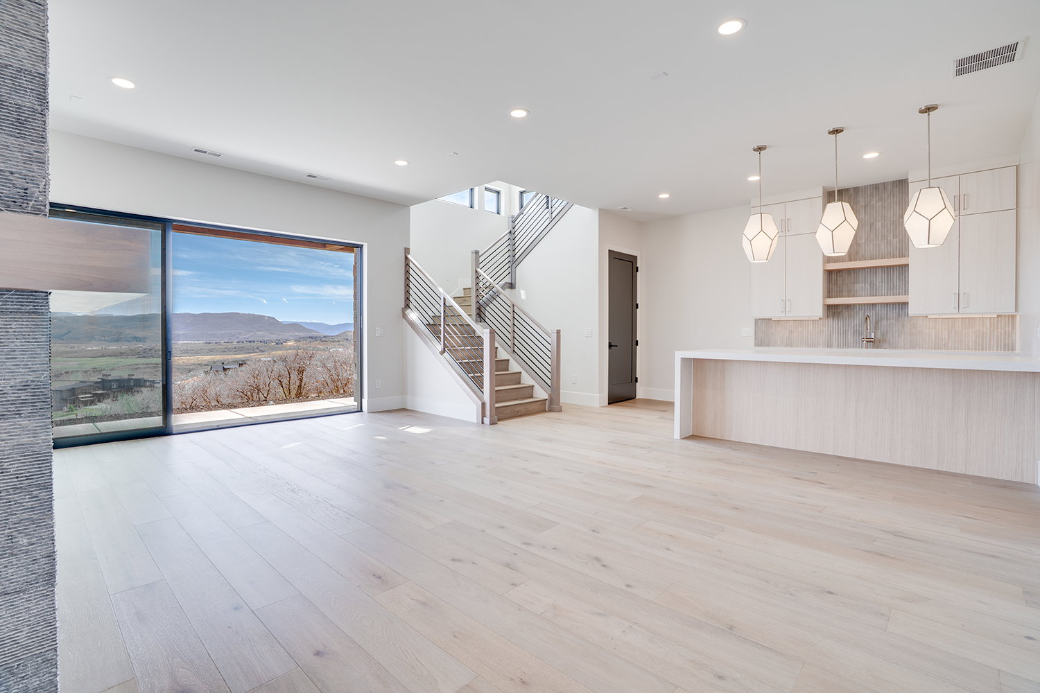 Unfurnished living room featuring a mountain view, light wood finished floors, and recessed lighting