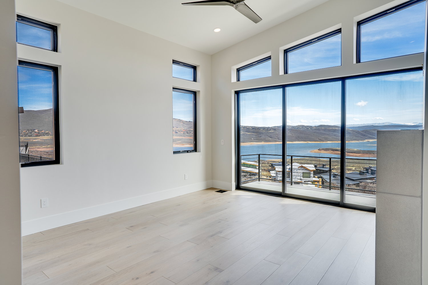 Primary Bedroom featuring a water and mountain view, a ceiling fan, healthy amount of natural light, light wood-type flooring, and recessed lighting