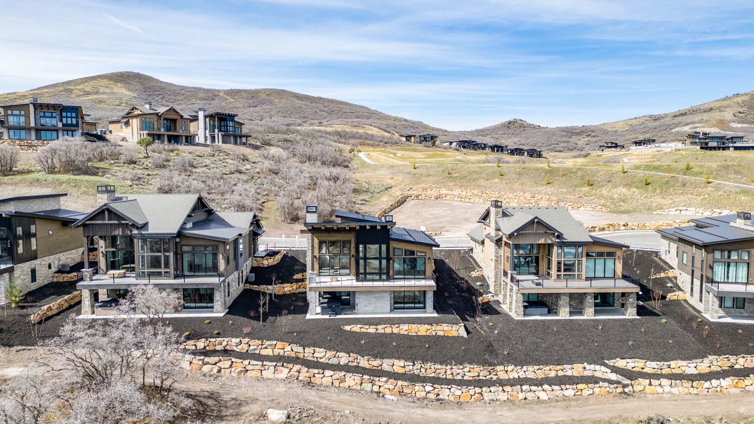 Rear view of property with a mountain view, a sunroom, and a chimney
