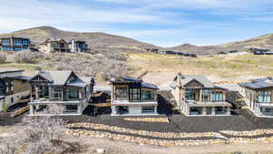 Rear view of property with a mountain view, a sunroom, and a chimney