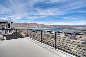 Balcony with a water and mountain view