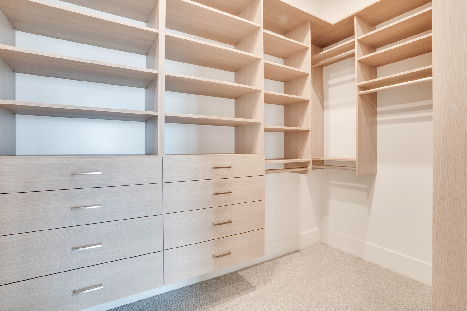 Walk in closet with light colored carpet