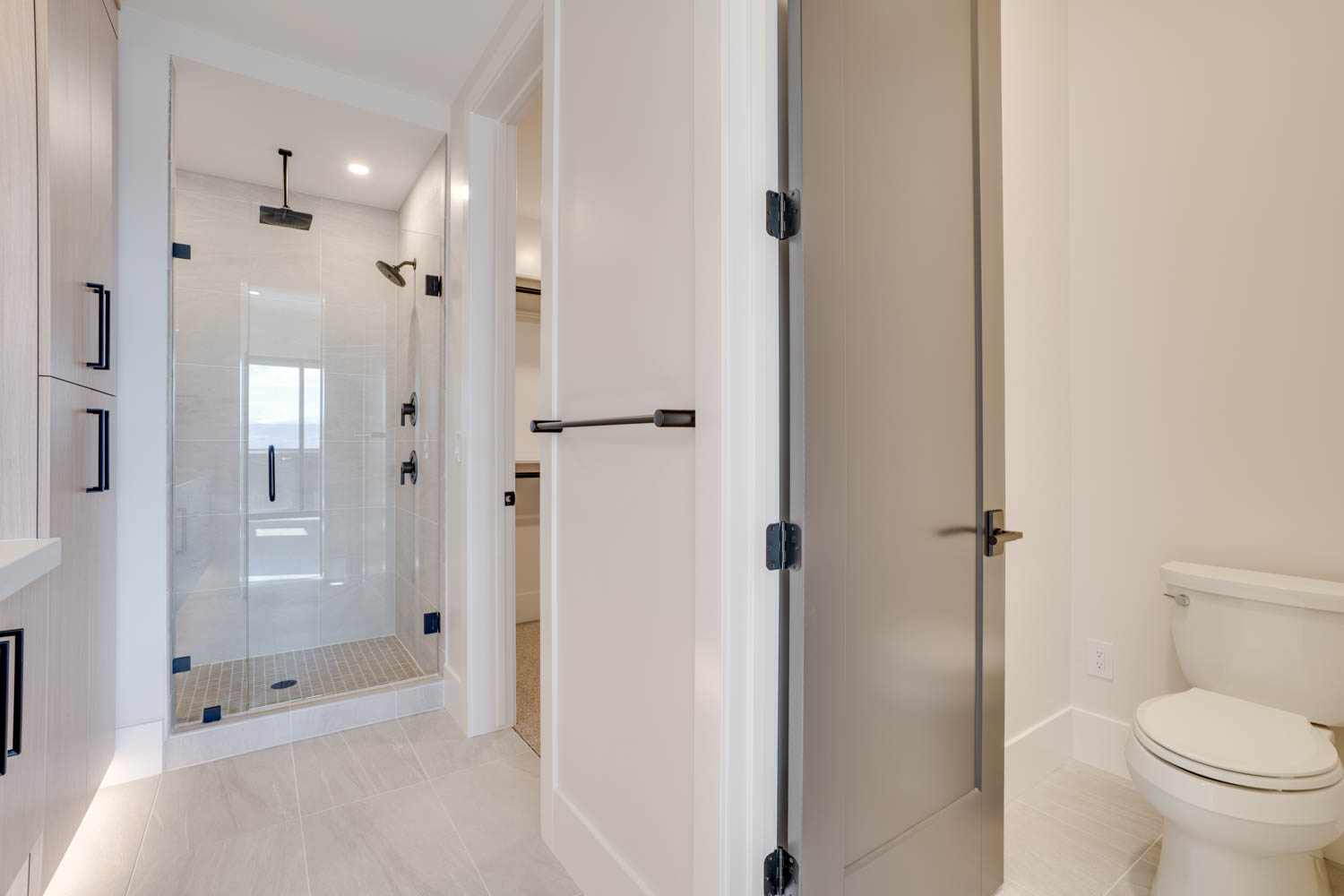 Bathroom featuring light tile patterned floors, a shower stall, and recessed lighting