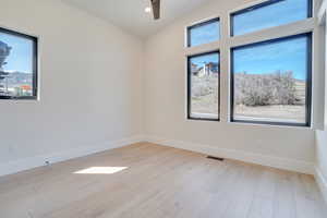 Empty room featuring light wood-style floors, recessed lighting, and ceiling fan