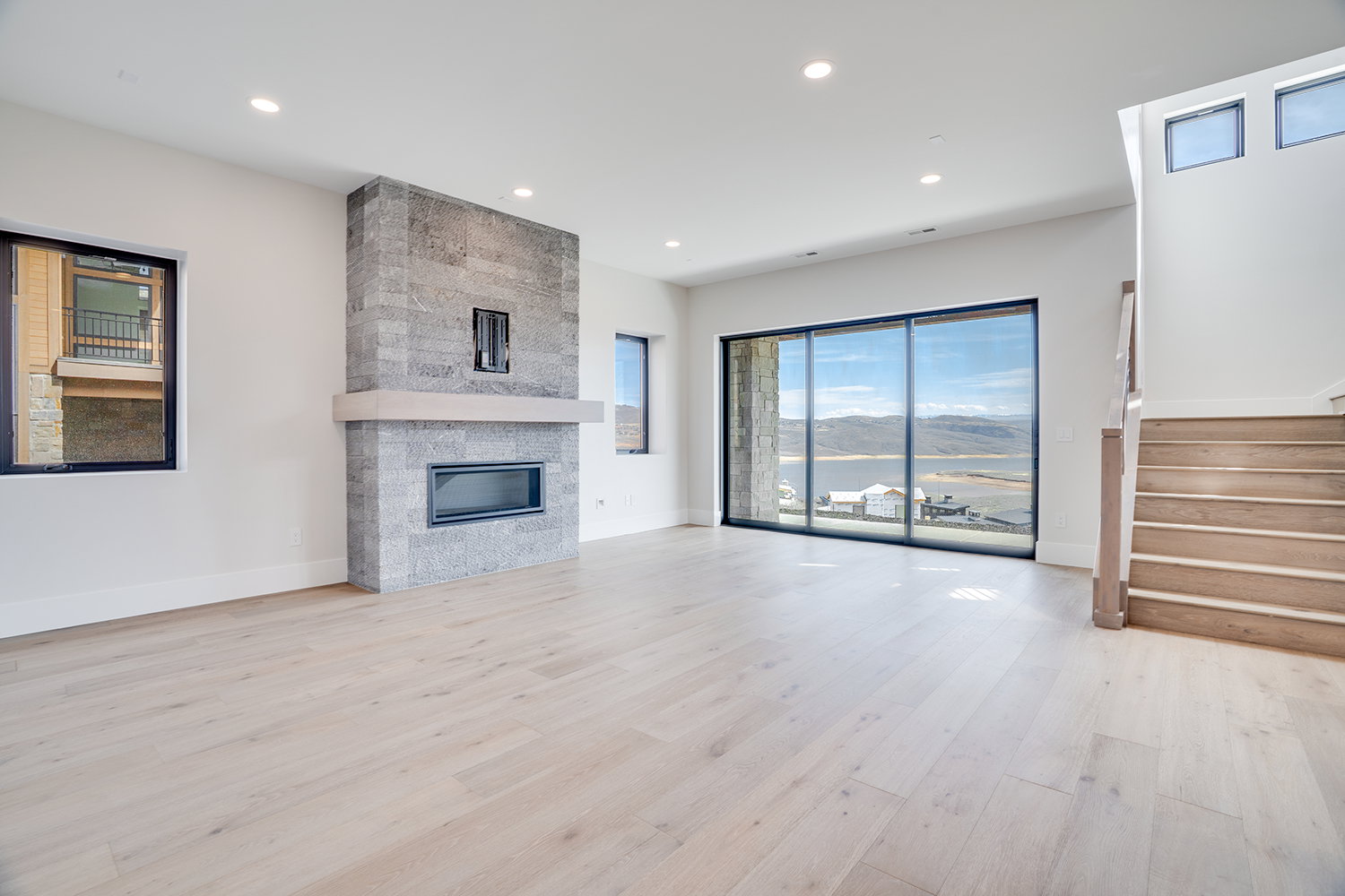 Unfurnished living room featuring a fireplace, light wood-style floors, and recessed lighting