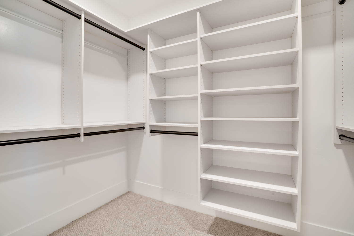 Walk in closet with light carpet