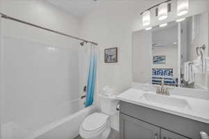 Bathroom featuring vanity, shower / bathtub combination with curtain, and ensuite bathroom