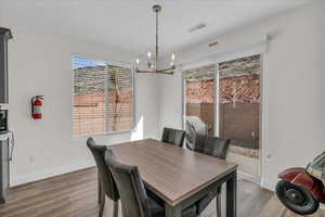 Dining space featuring light wood-type flooring and suspended lighting