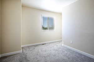 Unfurnished room featuring baseboards and light colored carpet