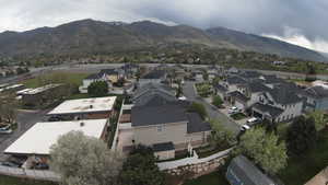Aerial perspective of suburban area featuring a mountain backdrop