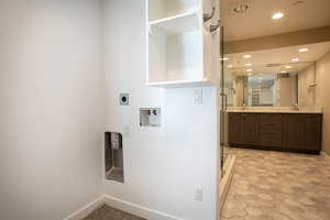 Laundry area with recessed lighting, hookup for an electric dryer, and washer hookup