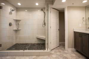 Full bathroom featuring vanity, recessed lighting, and a shower stall