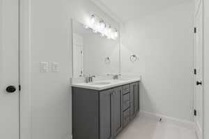 Full bath featuring double vanity and light tile patterned floors