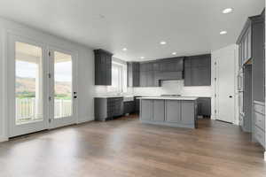 Kitchen featuring a center island, gray cabinetry, recessed lighting, light countertops, and light wood-style flooring