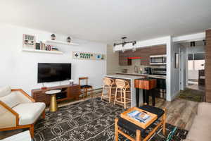 Living room featuring dark wood-style flooring