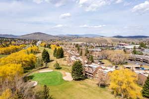 Aerial view of a mountainous background and a golf course