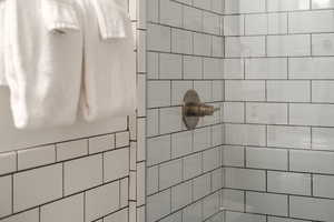 Full bath featuring a tile shower