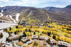 Aerial view of residential area featuring mountains and a local golf course