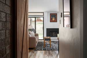 Living room with a large fireplace and light wood-style floors