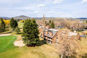 Aerial view of a mountainous background and a local golf course