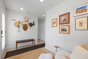 Living area with recessed lighting and light wood finished floors