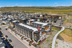 Aerial view of property and surrounding area with a mountainous background