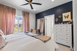 Bedroom with ceiling fan, recessed lighting, ensuite bath, and light carpet