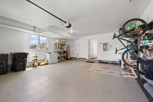 Garage featuring white refrigerator and electric panel