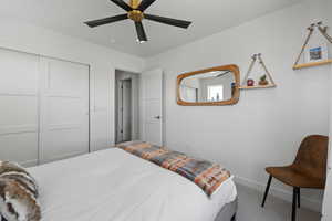 Bedroom featuring carpet floors, a ceiling fan, and a closet