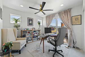 Home office with ceiling fan, recessed lighting, and light colored carpet