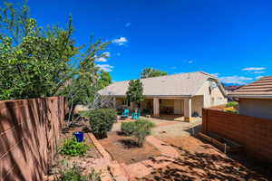 Rear view of property featuring a fenced backyard, a patio area, stucco siding, and a tile roof