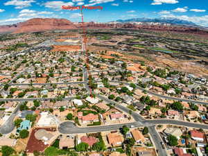 Aerial perspective of suburban area with a mountainous background