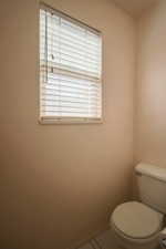 Bathroom with toilet and tile patterned floors