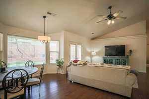 Living room with dark wood-style flooring, lofted ceiling, and ceiling fan
