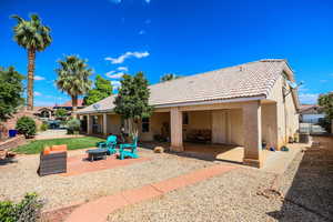 Rear view of property with a patio area, stucco siding, a fire pit, and a tile roof