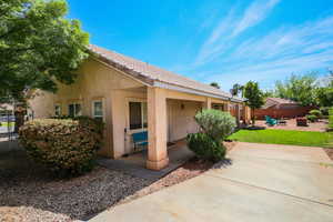 Back of house featuring a patio area, stucco siding, an outdoor fire pit, and a tiled roof