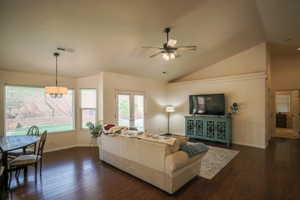 Living room with dark wood finished floors, ceiling fan, vaulted ceiling, and french doors
